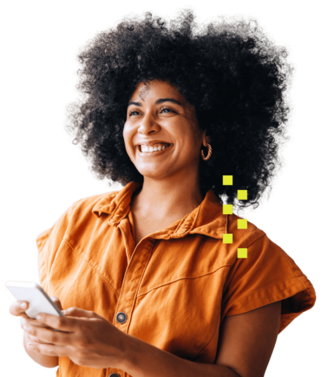 Light-skinned Black woman with natural hair smiling and holding a phone